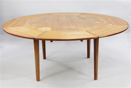 A Danish Dyrlund teak circular extending dining table, extends to W.5ft 9in.